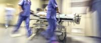 hospital photo of doctors transporting a patient